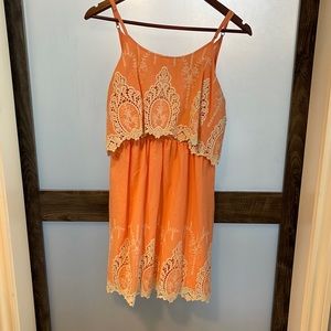 Cute peach colored dress with amazing detail in the stitching.
